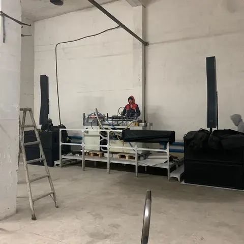 Ladders, equipment and a low stage in a performance space