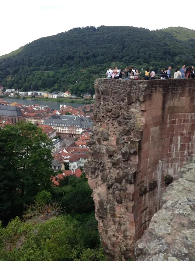 A hillside town seen from an old stone wall