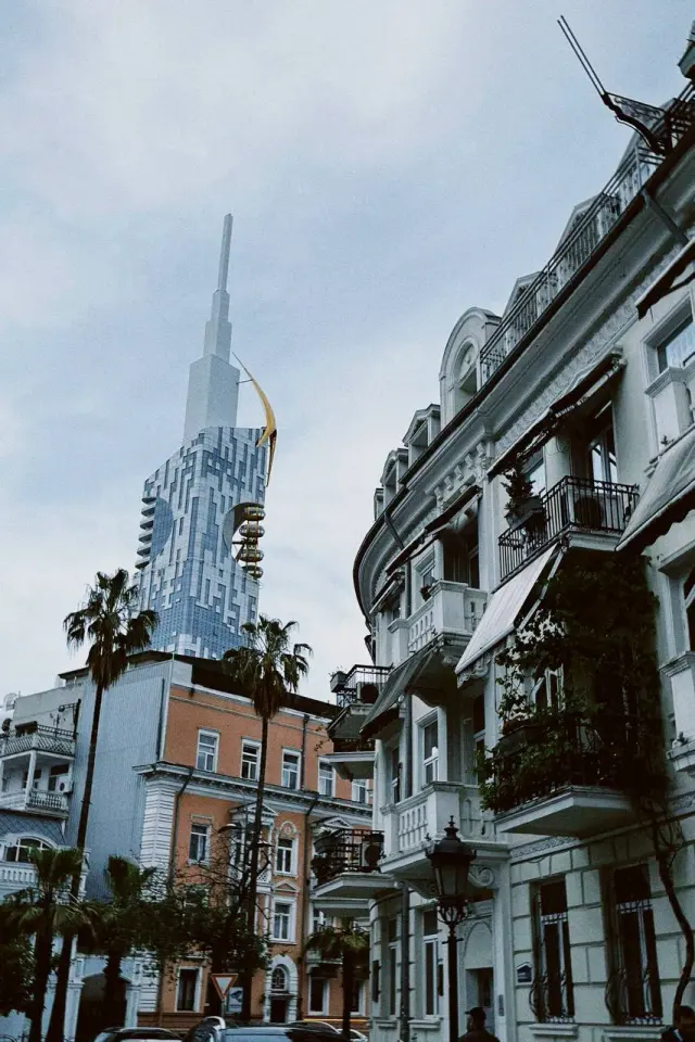 A tall modern tower above older city buildings