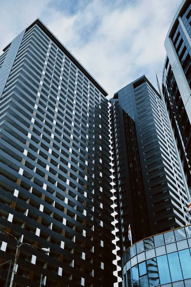 Apartment towers rising into a blue sky