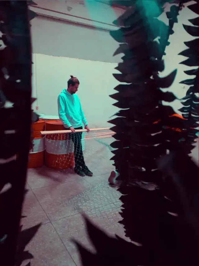 A performer surrounded by colourful projections