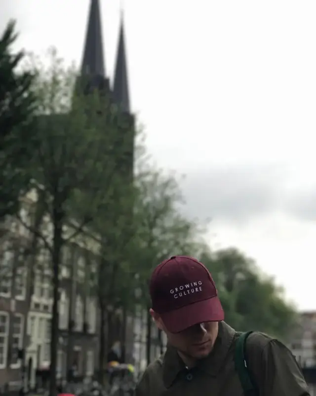 Alexey wearing a cap in front of church spires