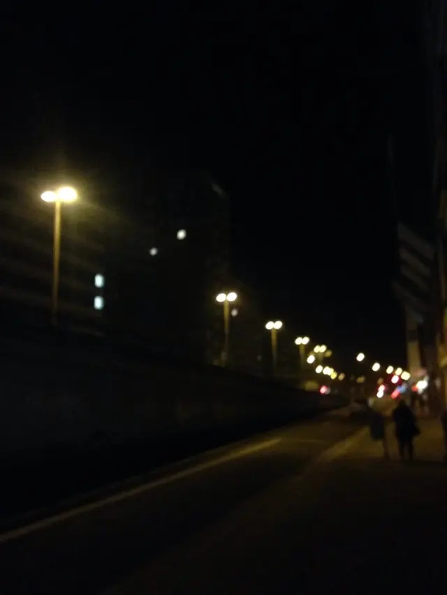 A railway platform lit up at night