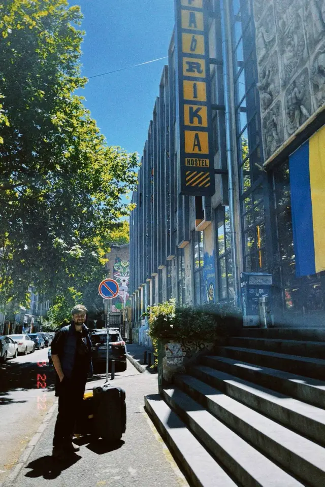 A sunny city street with steps and a cinema sign