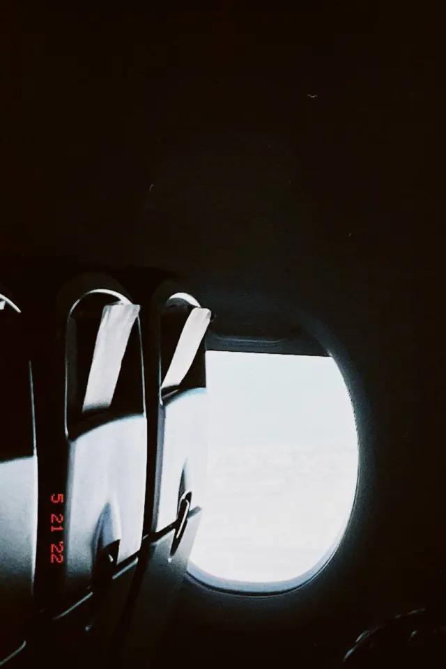 Light through an airplane window beside two seats